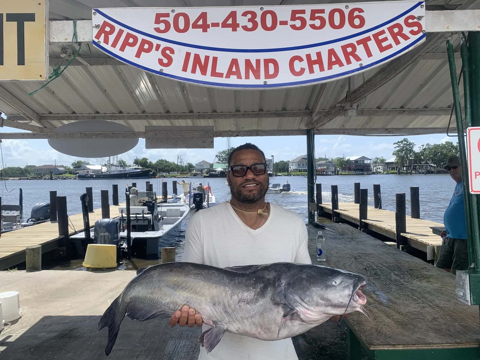 Angler holding a fish on a busy fishing boat