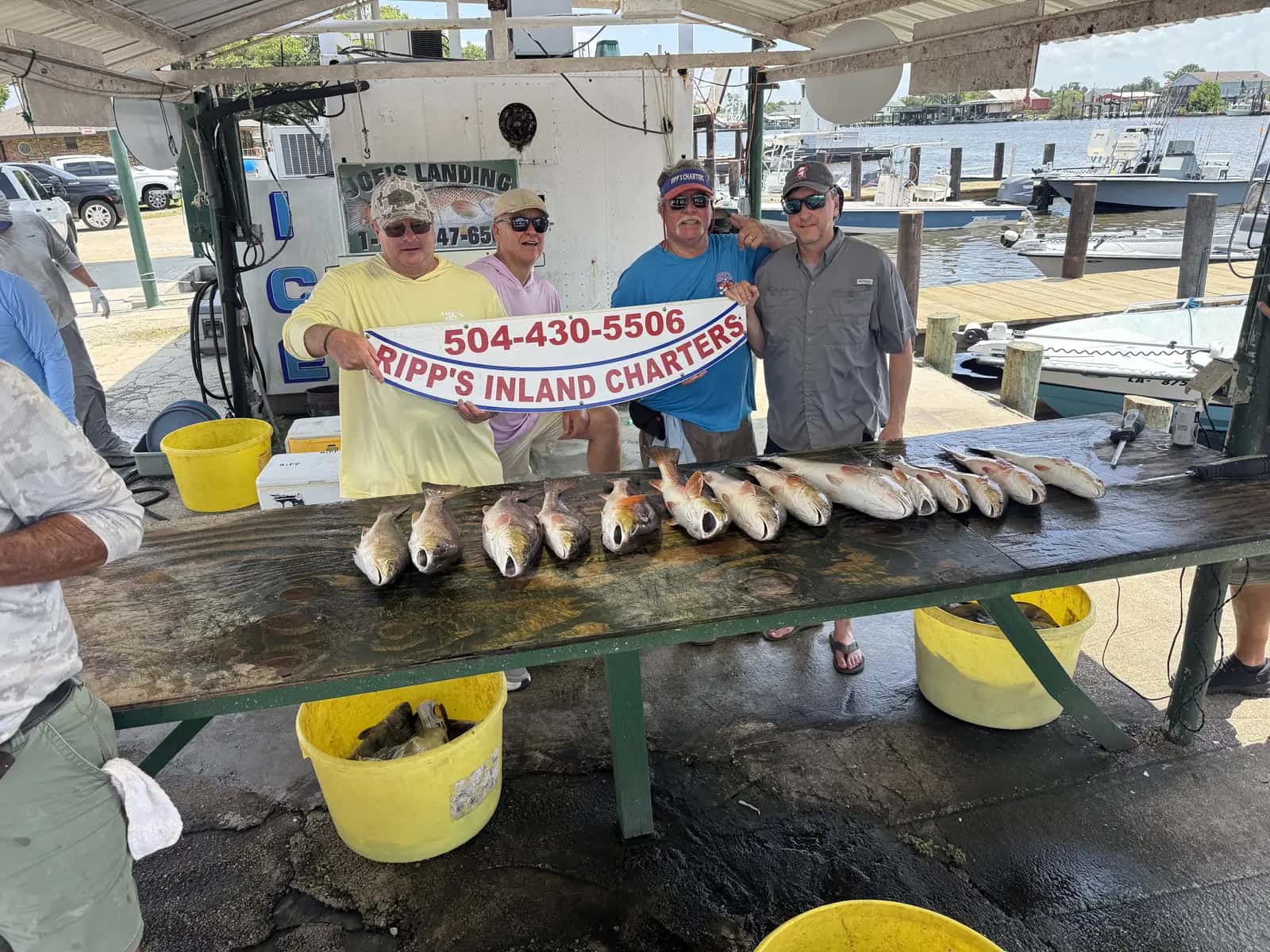 Charter group and catch display beneath the landing shelter