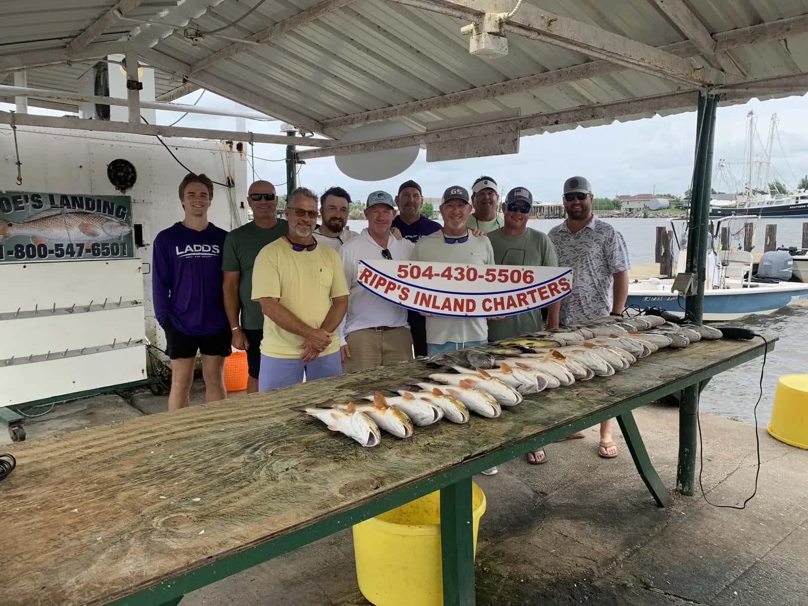 Charter group gathered with their catch at the landing