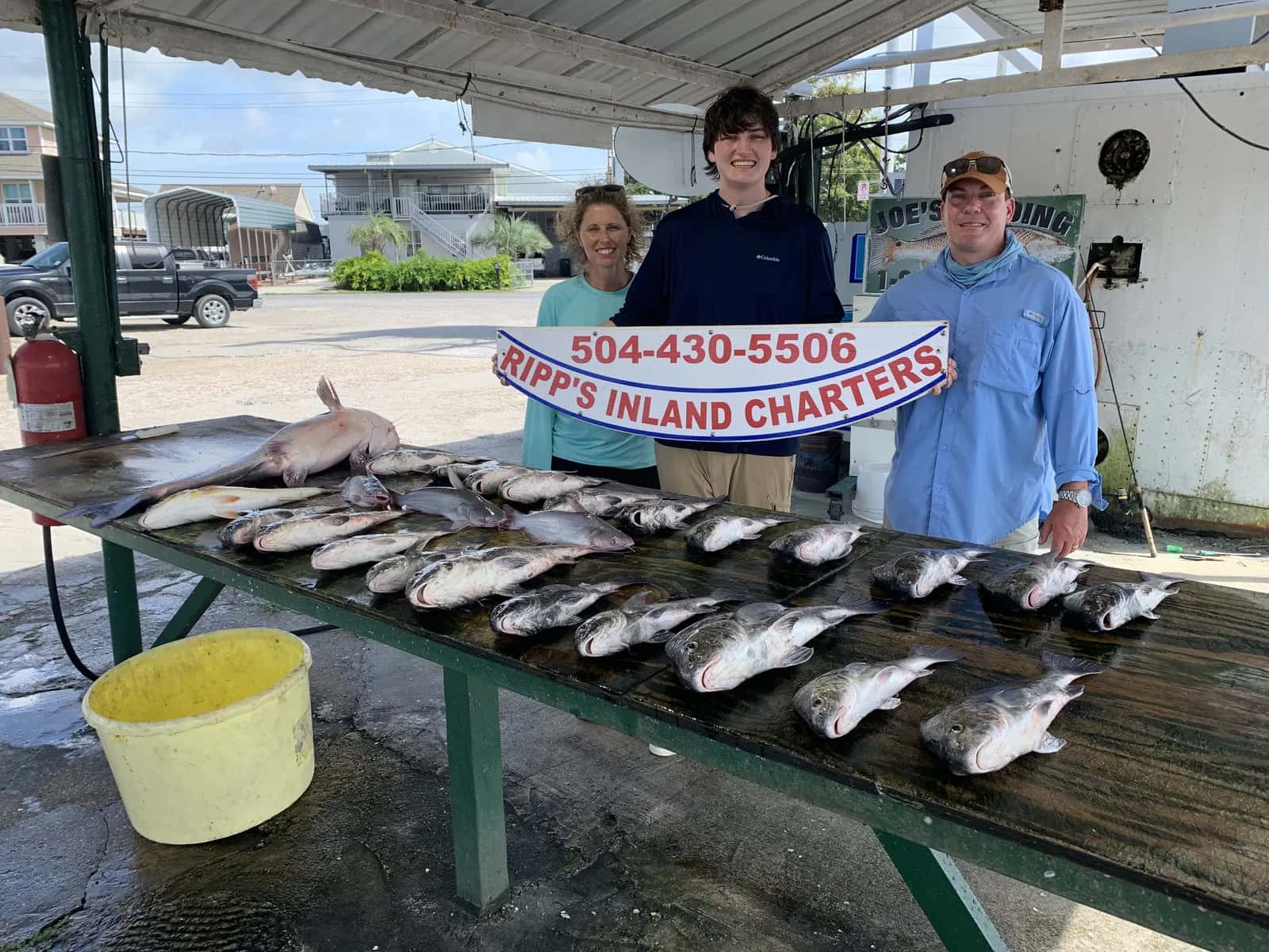 Charter group posing behind a catch display