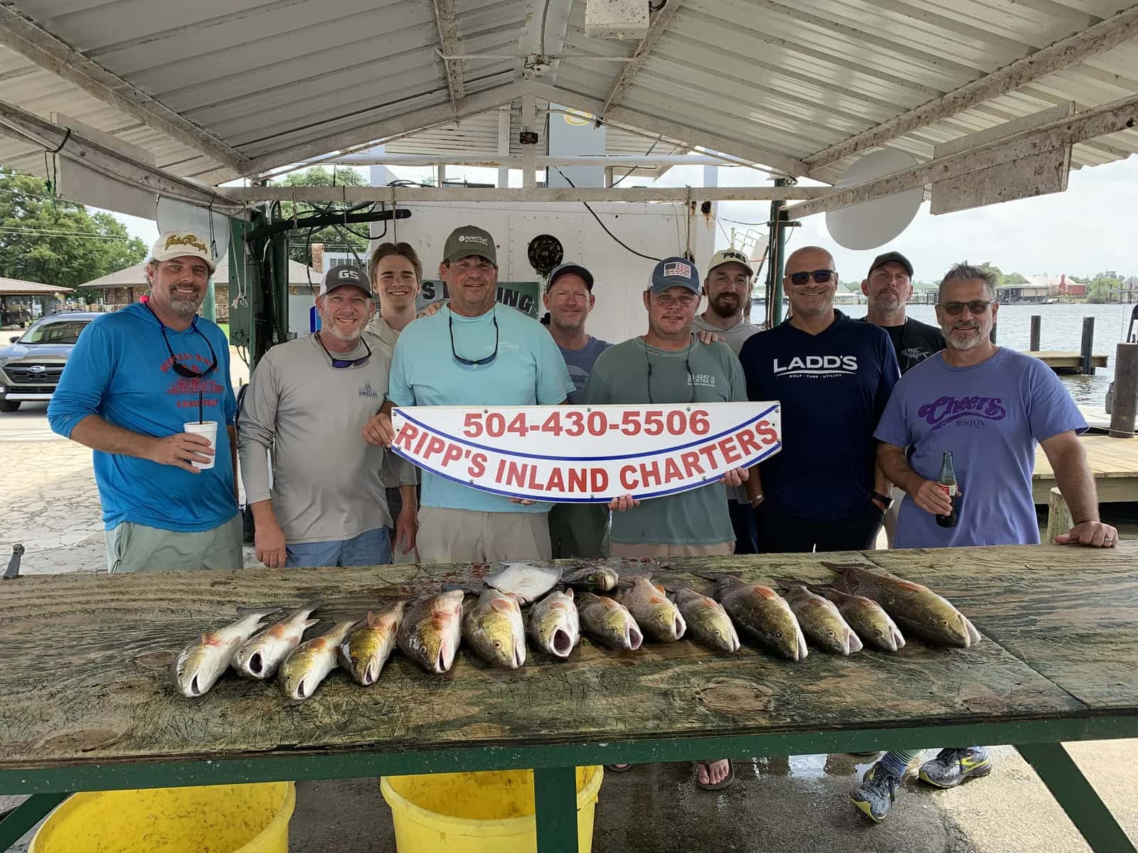 Charter group gathered behind a catch display at the landing