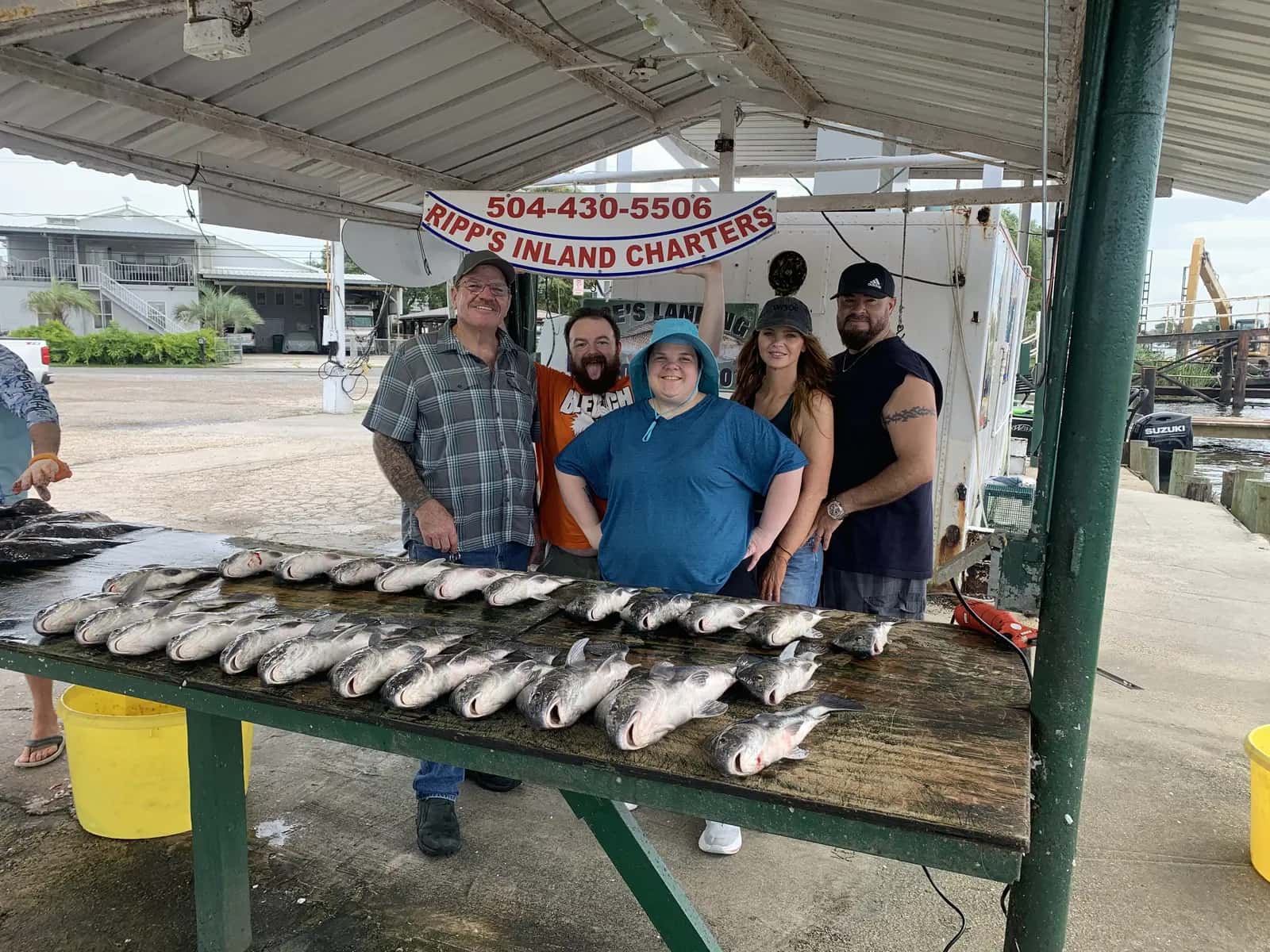 Charter party gathered behind a catch display at the landing