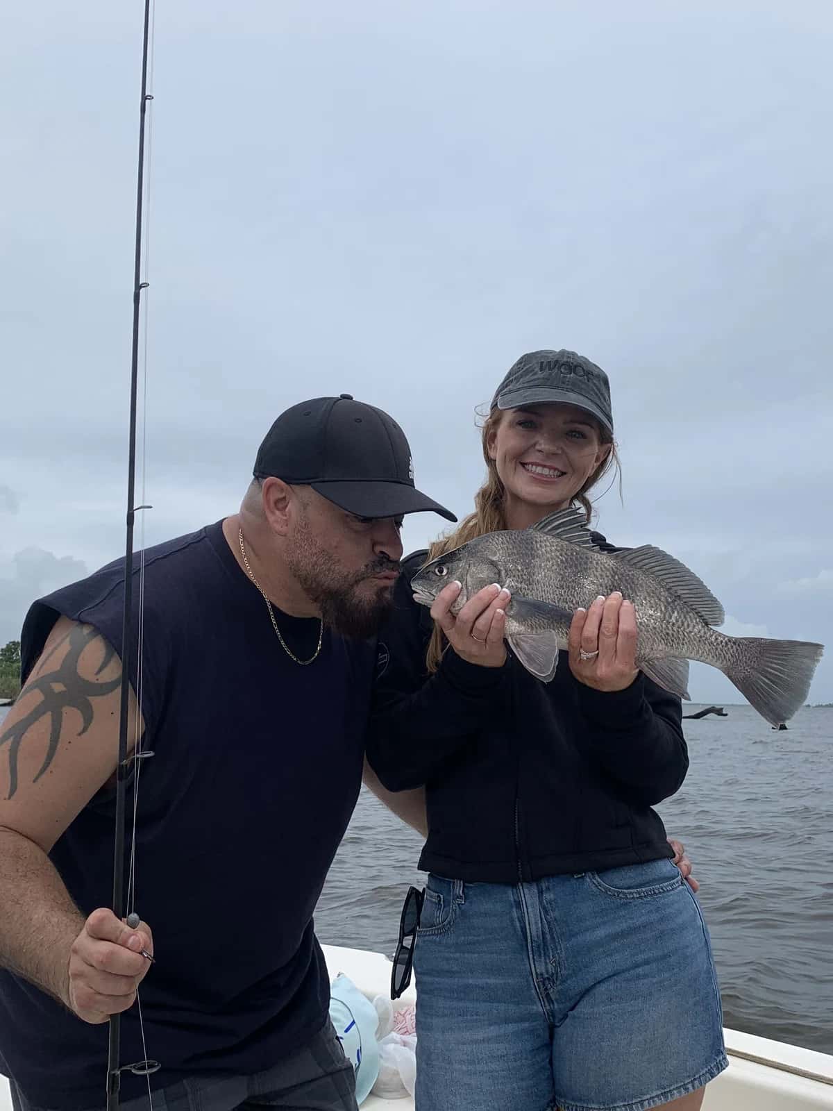 Two anglers celebrating a catch aboard the boat